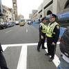 Photo: Boston Police, center, stand near the finish line Photo: Boston Police, center, stand near the finish line