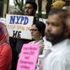 Photo: A group of people holds signs protesting the New Y Photo: A group of people holds signs protesting the New Y