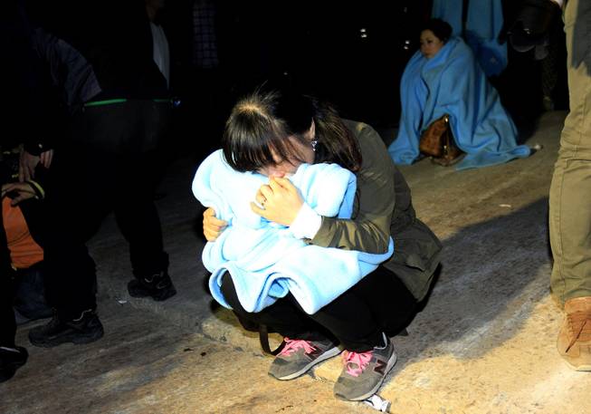 A relative cries as she waits for missing passengers at a port in Jindo, South Korea, Wednesday, April 16, 2014. A ferry carrying 459 people, mostly high school students on an overnight trip to a tourist island, sank off South Korea's southern coast on Wednesday, leaving nearly 300 people missing despite a frantic, hours-long rescue by dozens of ships and helicopters.