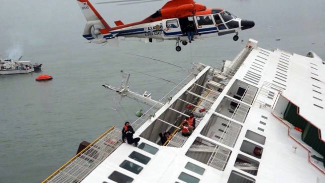In this image taken from video released by News Y via Yonhap, passengers from a ferry sinking off South Korea's southern coast, are rescued by a South Korean Coast Guard helicopter in the water off the southern coast near Jindo, south of Seoul, Wednesday, April 16, 2014. Nearly 300 people were still missing Wednesday several hours after the ferry carrying 477, most of them high school students, sank in cold waters off South Korea's southern coast.