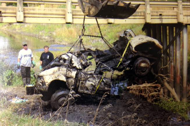 In this September 2013 photo provided by the South Dakota Attorney Generals Office, a 1960 Studebaker is lifted from Brule Creek near Alcester, S.D., next to a gravel pit Cheryl Miller and Pamella Jackson were driving to for a gathering with classmates to celebrate the end of the school year in 1971.