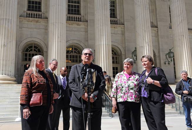 Plaintiffs challenging Oklahoma's gay marriage ban Dr. Gay Phillips, her partner Sue Barton, Sharon Baldwin and her partner Mary Bishop speak with members of the media after leaving court following a hearing at the 10th U.S. Circuit Court of Appeals in Denver, Thursday, April 17, 2014.