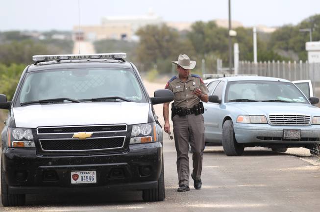 Texas Department of Public Safety Trooper Shawn Baxter waits to advise the media at the Yearning for Zion Ranch, Thursday, April 17, 2014, near Eldorado, Texas. State agents have seized the property, which belonged to the Fundamentalist Church of Jesus Christ of Latter Day Saints, and was where hundreds of children were removed during a 2008 FBI raid prompted by child sex abuse allegations.