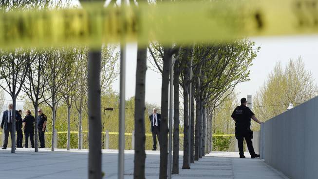Authorities secure the plaza as police investigate a shooting inside the Federal Courthouse, Monday, April 21, 2014, in Salt Lake City. A U.S. marshal shot and critically wounded a defendant on Monday in a new federal courthouse after the man rushed the witness stand with a pen at his trial in Salt Lake City, authorities said.