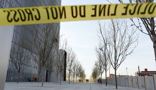 Authorities investigate a shooting inside the Federal Courthouse, Monday, April 21, 2014, in Salt Lake City. A U.S. marshal shot and critically wounded a defendant on Monday in a new federal courthouse after the man rushed the witness stand with a pen at his trial in Salt Lake City, authorities said.