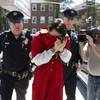 Photo: Neil K. Scott covers his face as he is led into Mo Photo: Neil K. Scott covers his face as he is led into Mo