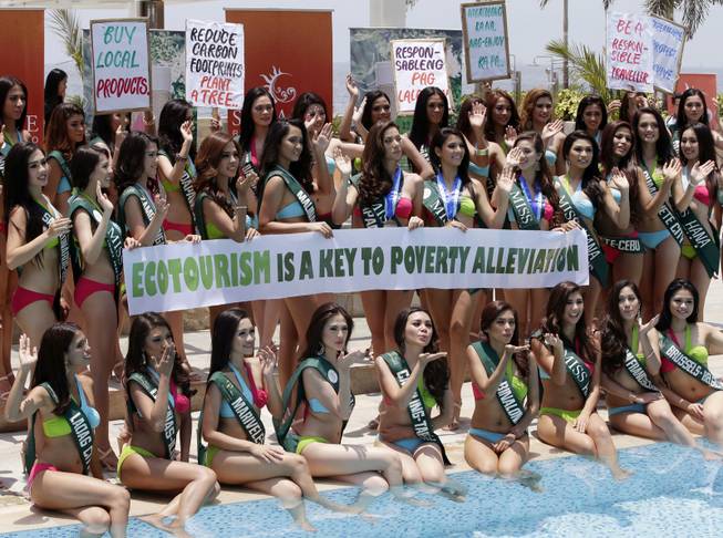 Candidates for the Miss Earth 2014 Philippines beauty pageant display Earth Day messages Monday, April 22, 2014 by the poolside of a hotel-casino at suburban Pasay city, south of Manila, Philippines. Some 49 candidates are vying for the title of the only beauty pageant with a unique theme of saving Mother Earth.