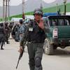 Photo: An Afghan policeman prevents journalists from appr Photo: An Afghan policeman prevents journalists from appr