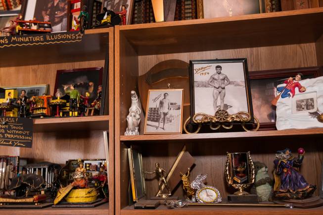 Photographs of Gary Darwin in pristine athletic shape are shown on the shelves with his magician collectibles and memorabilia in his home during the Rebuilding Together Southern Nevada's annual neighborhood rebuilding event in Las Vegas Saturday, April 26, 2014. Former magician Gary Darwin lost his right leg to diabetes and now is confined to a wheelchair.