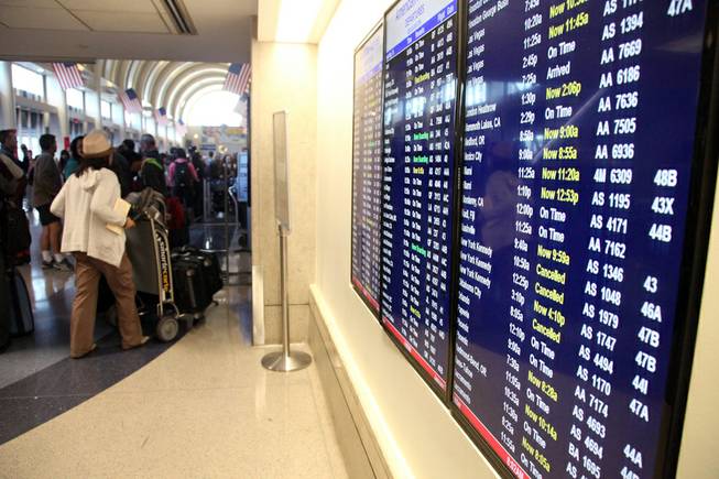 A file photo from Jan. 3, 2014, shows a departure board listing flights canceled due to weather, Friday, Jan. 3, 2014, at Los Angeles International Airport. More than 30 departing flights were held on the ground for about an hour because of computer problems, Wednesday, April 30, 2014, according to an airport spokeswoman.