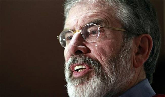 In this Tuesday, Dec. 31, 2013 file photo, Sinn Fein President Gerry Adams speaks to the media at Stormont Hotel, Belfast, Northern Ireland. Northern Ireland police say they have arrested Sinn Fein leader Gerry Adams on suspicion of involvement in the Irish Republican Army's 1972 abduction, killing and secret burial of a Belfast widow.