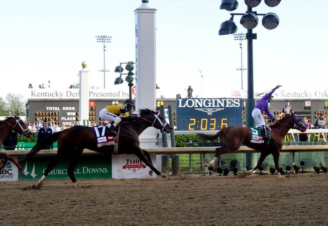 IMAGE DISTRIBUTED FOR LONGINES - California Chrome, ridden by jockey Victor Espinoza, celebrates as he wins the 140th Kentucky Derby, Saturday, May 3, 2014, in Louisville, Ky. Longines, the Swiss watchmaker known for its famous timepieces, is the Official Watch and Timekeeper of the 140th annual Kentucky Derby. (Photo by Diane Bondareff/Invision for Longines/AP Images)