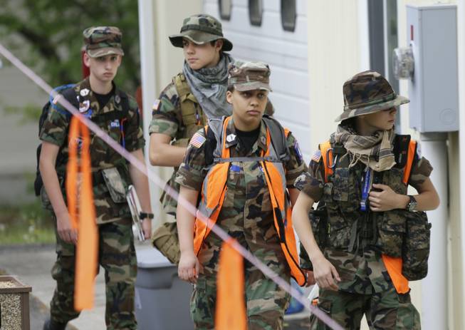 A search team arrives at a command post for the recovery efforts from a hot air balloon accident in Ruther Glen, Va., Saturday, May 10, 2014. The body of two occupants of a hot air balloon that caught fire after striking a power line and crashed have been recovered, and police searched Saturday for one other feared dead, Virginia State Police said.