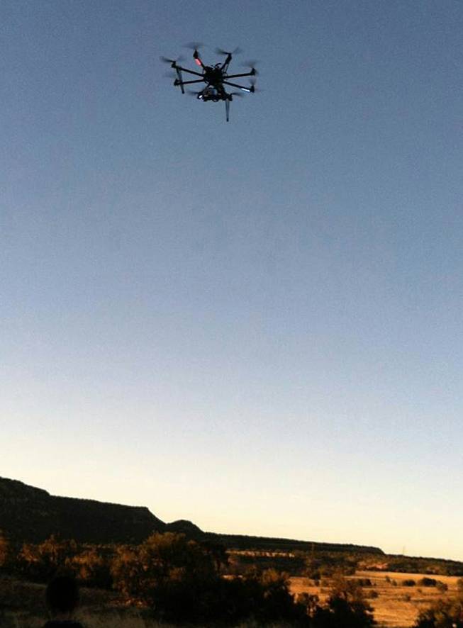 This June 2013 photo provided by the University of North Florida Office of Research shows a drone at the Blue J area in northwestern New Mexico. Researchers outfitted a customized drone with a heat-sensing camera to unearth what they believe are ceremonial pits and other features at the site of an ancient village in New Mexico. (AP Photo/Cynthia Hotujec-Kantner)