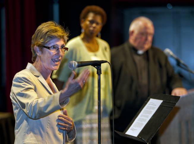 Clark County Commissioner Chris Giunchigliani speaks on elder transportation issues during the Nevadans for the Common Good second community convention at the Cashman Center on Tuesday, May 13, 2014. Co-chairs Rev. Camille D. Pentsil and Rev. Bob Stoeckig listen with others to her response.