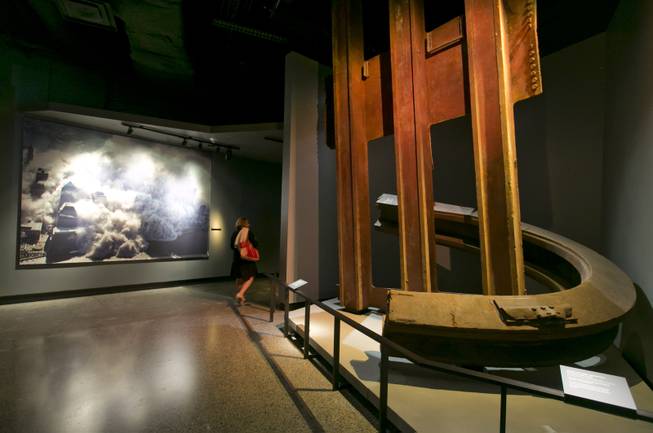 A two-inch thick World Trade Center steel column, that was bent into a horseshoe shape, and facade segment, are displayed at the National Sept. 11 Memorial Museum, Wednesday, May 14, 2014, in New York. The museum is a monument to how the Sept. 11 terror attacks shaped history, from its heart-wrenching artifacts to the underground space that houses them amid the remnants of the fallen twin towers' foundations. It also reflects the complexity of crafting a public understanding of the terrorist attacks and reconceiving ground zero. (AP Photo)