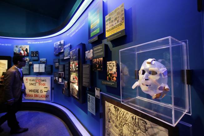 The burn mask, right, of a World Trade Center survivor who was injured by burning jet fuel, is displayed at the National Sept. 11 Memorial Museum, Wednesday, May 14, 2014, in New York. The museum is a monument to how the Sept. 11 terror attacks shaped history, from its heart-wrenching artifacts to the underground space that houses them amid the remnants of the fallen twin towers' foundations. It also reflects the complexity of crafting a public understanding of the terrorist attacks and reconceiving ground zero. (AP Photo)