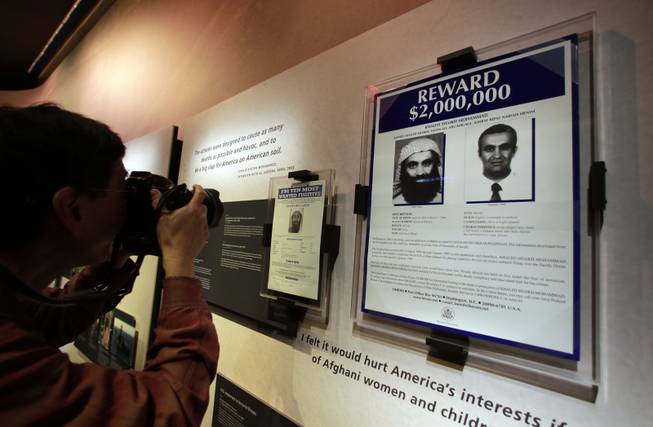 The wanted posters of Osama Bin Laden, left, and Khaled Shaikh Mohammad are displayed at the National Sept. 11 Memorial Museum, Wednesday, May 14, 2014, in New York. The museum is a monument to how the Sept. 11 terror attacks shaped history, from its heart-wrenching artifacts to the underground space that houses them amid the remnants of the fallen twin towers' foundations. It also reflects the complexity of crafting a public understanding of the terrorist attacks and reconceiving ground zero. (AP Photo)