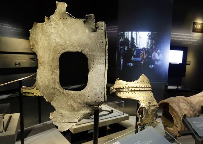 Fragments of the fuselage of Flight 11, that hit the World Trader Center, are displayed at the National Sept. 11 Memorial Museum, Wednesday, May 14, 2014, in New York. The museum is a monument to how the Sept. 11 terror attacks shaped history, from its heart-wrenching artifacts to the underground space that houses them amid the remnants of the fallen twin towers' foundations. It also reflects the complexity of crafting a public understanding of the terrorist attacks and reconceiving ground zero. (AP Photo)