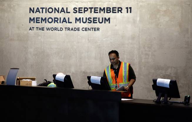 A technician readies computers at the National Sept. 11 Memorial Museum, Wednesday, May 14, 2014, in New York. The museum is a monument to how the Sept. 11 terror attacks shaped history, from its heart-wrenching artifacts to the underground space that houses them amid the remnants of the fallen twin towers' foundations. It also reflects the complexity of crafting a public understanding of the terrorist attacks and reconceiving ground zero. (AP Photo)