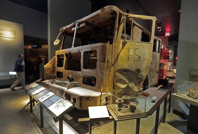 The remains of New York City Fire Dept. truck from Engine Company 21 are displayed at the National Sept. 11 Memorial Museum, Wednesday, May 14, 2014, in New York. The museum is a monument to how the Sept. 11 terror attacks shaped history, from its heart-wrenching artifacts to the underground space that houses them amid the remnants of the fallen twin towers' foundations. It also reflects the complexity of crafting a public understanding of the terrorist attacks and reconceiving ground zero. (AP Photo)