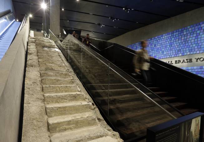 The "Survivor Stairs," left, from The World Trader Center, are displayed at the National Sept. 11 Memorial Museum, Wednesday, May 14, 2014, in New York. The museum is a monument to how the Sept. 11 terror attacks shaped history, from its heart-wrenching artifacts to the underground space that houses them amid the remnants of the fallen twin towers' foundations. It also reflects the complexity of crafting a public understanding of the terrorist attacks and reconceiving ground zero. (AP Photo)