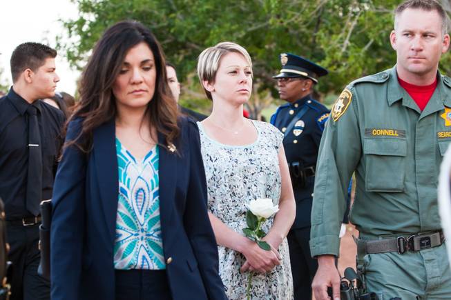 Escorted by LVMPD Search and Rescue Officer Connell, family members of fallen officer LVMPD Search and Rescue Officer David VanBuskirk join other families in the honor march during the Southern Nevada Law Enforcement Memorial ceremony at Police Memorial Park in Las Vegas Thursday, May 22, 2014.