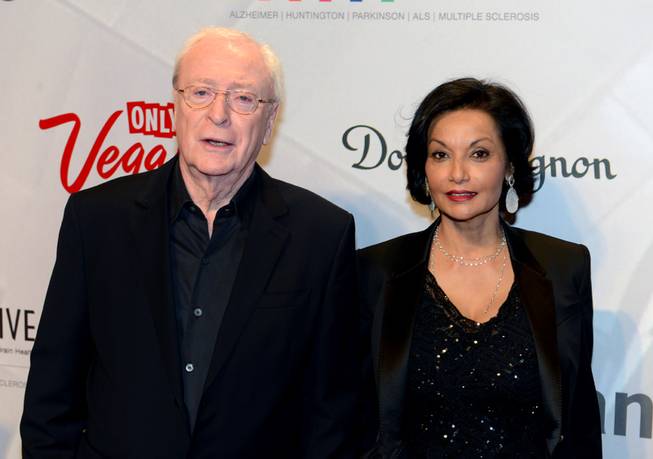 In this photo provided by the Las Vegas News Bureau, Sir Michael Caine and wife Shakira arrive for the 17th annual Keep Memory Alive Power of Love Gala at MGM Grand Garden Arena in Las Vegas will raise funds for Cleveland Clinic Lou Ruvo Center for Brain Health and its fight against neurodegenerative brain diseases.
