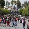 Photo: Patrons walk along Main Street in Disneyland on Tu Photo: Patrons walk along Main Street in Disneyland on Tu