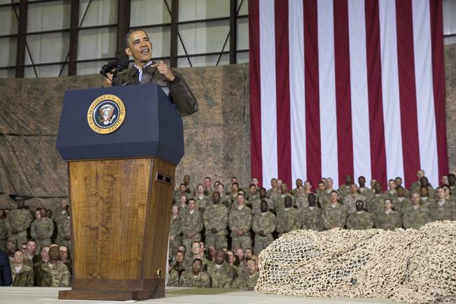 This May 25, 2014, file photo shows President Barack Obama speaking during a troop rally after arriving at Bagram Air Field for an unannounced visit, north of Kabul, Afghanistan. Senior U.S. administration officials say Obama will seek to keep 9,800 U.S. troops in Afghanistan after the war formally ends later this year. Nearly all of those forces are to be out by the end of 2016, as Obama finishes his second term.