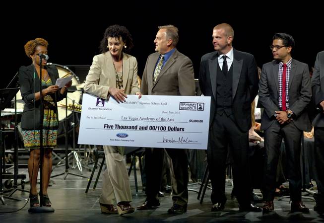 Qiana Conley and Zoe Thrall present a GRAMMY Signature Schools Gold Award for the Las Vegas Academy of the Arts for achieving GRAMMY Signature Schools Gold status on Wednesday, May 28, 2014. Thrall is studio director of Studio at the Palms and Conley is governor of the Los Angeles Chapter of The Recording Academy and music industry professionals.