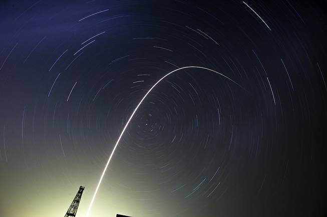 The Soyuz-FG rocket booster with Soyuz TMA-13M space ship carrying a new crew to the International Space Station, ISS, flies in the sky at the Russian leased Baikonur cosmodrome, Kazakhstan, Thursday, May 29, 2014. Circular star tracks around the Polar Star and track of the rocket are the result of the longtime exposure.