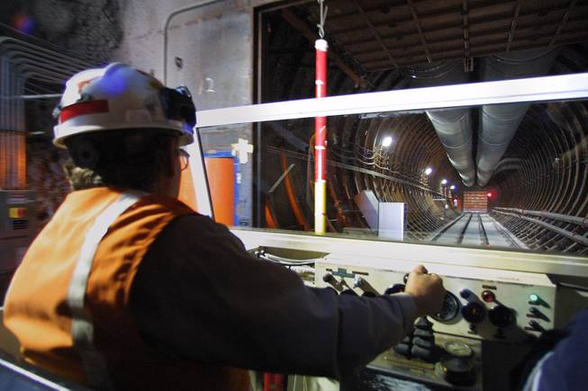 A driver ferries journalists in a cart in the Yucca Mountain Project to examine the drift scale test tunnel during a public open house Saturday, November 3, 2001. The tunnel and surrounding rock has been heated to an average 392 degrees for the past four years and then will be allowed to cool beginning January 2002 for another four years to study the effect on the movement of water through Yucca Mountain.