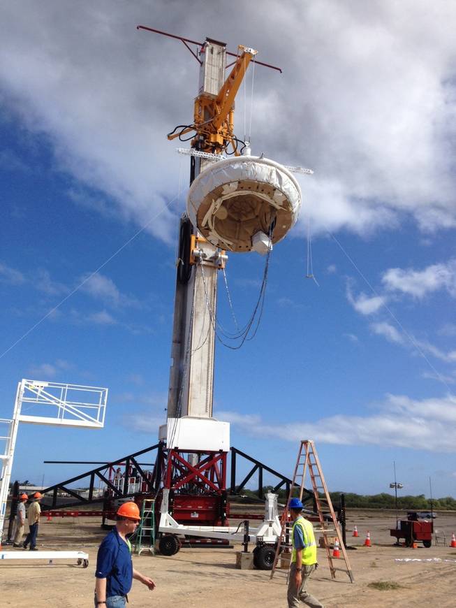 This April 23, 2014, image provided by NASA shows NASA’s saucer-shaped experimental flight vehicle being prepared for a Range Compatibility Test at the at the U.S Navy's Pacific Missile Range Facility at Kekaha on the island of Kaua‘i in Hawaii. The vehicle, part of the Low Density Supersonic Decelerator project, will test an inflatable decelerator and a parachute at high altitudes and speeds over the Pacific Missile Range scheduled for June 1, 2014.