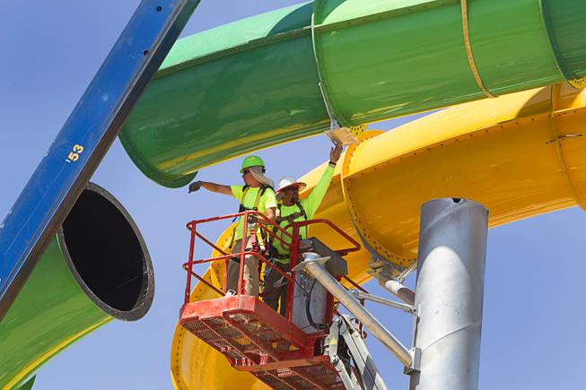 Workers line up the final piece of the "Breaker 1-9" water slide at the Cowabunga Bay water park in Henderson Thursday, June 5, 2014. Developers announced today that the water park will open July 4. The park includes a 32,000-square-foot wave pool, water slides and a 1,200-foot-long lazy river.