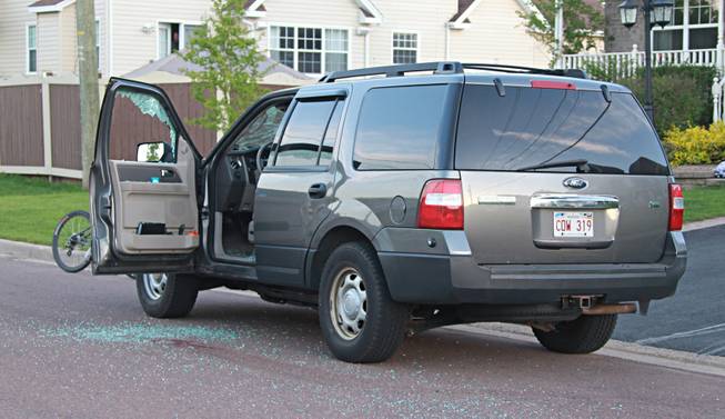An unmarked police vehicle sits on Mailhot Avenue with the window shot out in Moncton, New Brunswic on Wednesday June 4, 2014. The Royal Canadian Mounted Police says three of its officers were killed in Moncton, New Brunswick, by a man armed with guns and two other officers were injured as the Mounties conducted a manhunt across the city's north end on Wednesday night for the shooter.