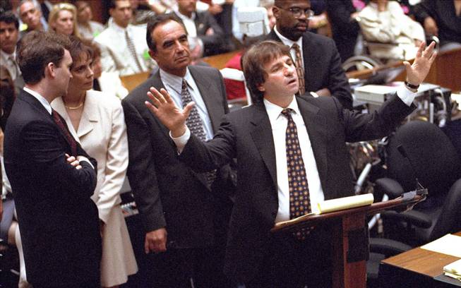 In this Sept. 15, 1995, file photo, defense attorney Barry Scheck, center, cross examines prosecution witness William Bodziak as, from left, Hank Goldberg, Marcia Clark, Robert Shapiro, and Christopher Darden look on during the O.J. Simpson double-murder trial in Los Angeles. Scheck, the lawyer who introduced the science of DNA to jurors and to the public watching the trial on TV, attacked police methods of evidence collection and demolished the prosecution’s forensic evidence case.