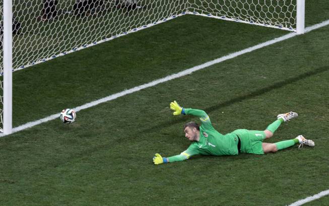 Croatia's goalkeeper Stipe Pletikosa fails to make a safe as Brazil's Oscar scores his side's third goal during the group A World Cup soccer match between Brazil and Croatia, the opening game of the tournament, in the Itaquerao Stadium in Sao Paulo, Brazil, Thursday, June 12, 2014.