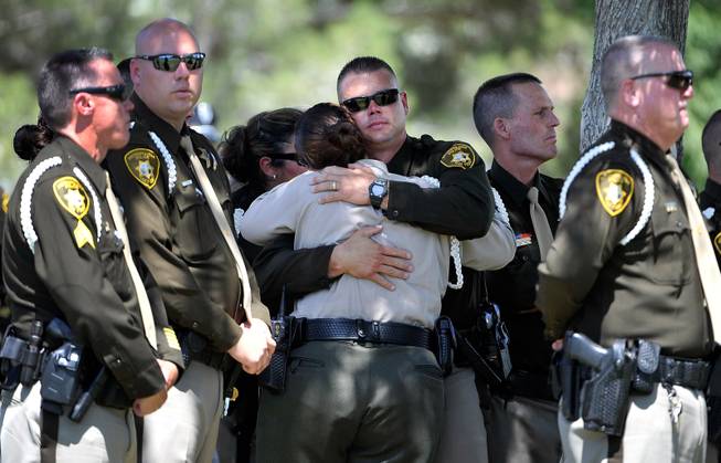 Las Vegas police officers console each during funeral services for Las Vegas police officer Igor Soldo at Palm Northwest Mortuary & Cemetery on Thursday, June 12, 2014 in Las Vegas. Soldo, 31, and fellow officer, Alyn Beck, 41, were gun down by two assailants at a Cici's Pizza during their lunch break Sunday. Services for Beck are scheduled for Saturday.