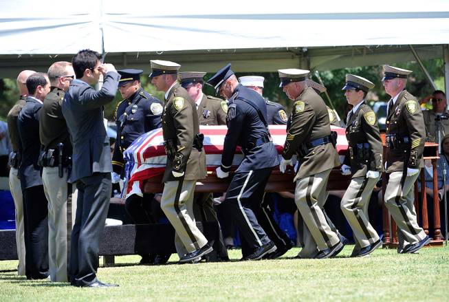 Police honor guard members carry the casket of Las Vegas police officer Igor Soldo for his funeral at Palm Northwest Mortuary & Cemetery on Thursday, June 12, 2014 in Las Vegas. Soldo, 31, and fellow officer, Alyn Beck, 41, were gun down by two assailants at a Cici's Pizza during their lunch break Sunday. Services for Beck are scheduled for Saturday.