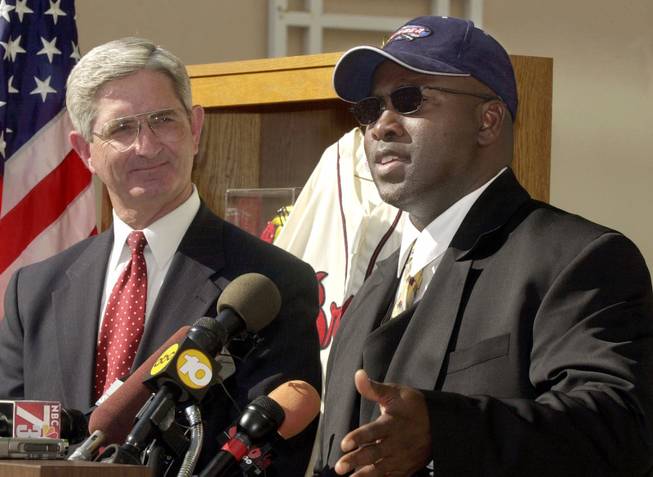 San Diego Padres' Tony Gwynn, right, talks at news conference at FBI Headquarters in San Diego as Special Agent-In-Charge Willam Gore looks on Wednesday, April 12, 2000. The FBI and the IRS seized over $10 million worth of counterfeit memorabilia after executing warrants in five states.