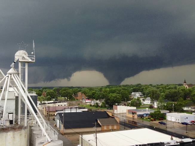 This photo taken on June 16, 2014 from atop the Wisner, Neb., grain elevator and made available on Tuesday, June 17, 2014, shows a tornado approaching Pilger, Neb. A storm packing rare dual tornadoes tore through northeast Nebraska, crumpling grain bins and flattening dozens of homes.