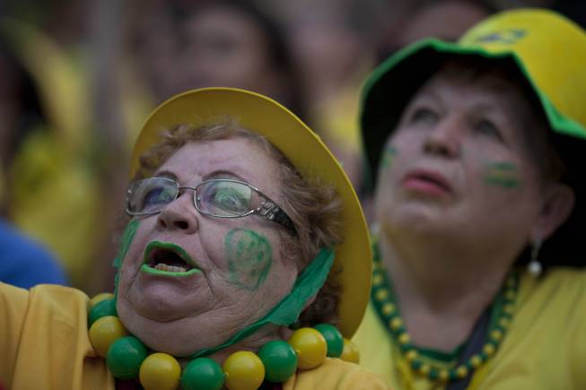 A fan of the Brazilian national soccer team watches the Mexico vs. Brazil match at the FIFA Fan Fest, during the 2014 soccer World Cup in Sao Paulo, Brazil, Tuesday, June 17, 2014. Mexico claimed a deserved point against Brazil in a largely frustrating Group A game which finished 0-0 at Estadio Castelao in Fortaleza. (AP Photo/Dario Lopez-Mills)