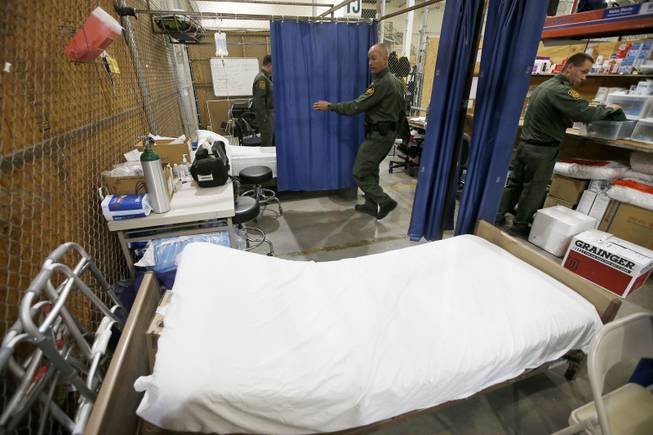 U.S. Customs and Border Protection staff a medical section where if needed the hundreds of mostly Central American immigrant children can get medical attention as they are being processed and held at the U.S. Customs and Border Protection Nogales Placement Center on Wednesday, June 18, 2014, in Nogales, Ariz. CPB provided media tours Wednesday of two locations in Brownsville, Texas, and Nogales, that have been central to processing the more than 47,000 unaccompanied children who have entered the country illegally since Oct. 1. (AP Photo/Ross D. Franklin, Pool)