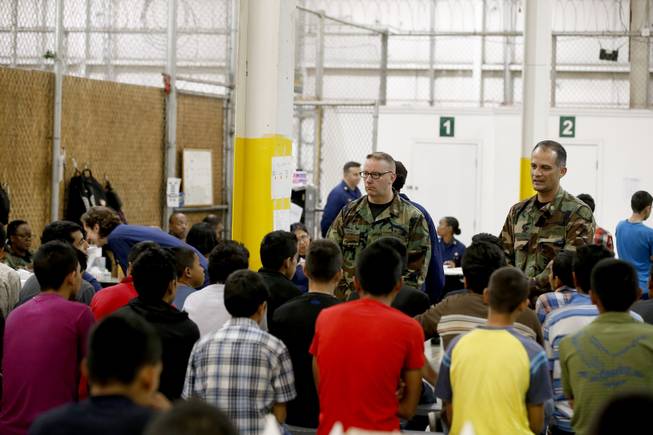 Boys await medical appointments in a holding area where hundreds of mostly Central American immigrant children are being processed and held at the U.S. Customs and Border Protection Nogales Placement Center on Wednesday, June 18, 2014, in Nogales, Ariz. CPB provided media tours Wednesday of two locations in Brownsville, Texas, and Nogales, that have been central to processing the more than 47,000 unaccompanied children who have entered the country illegally since Oct. 1. (AP Photo/Ross D. Franklin, Pool)