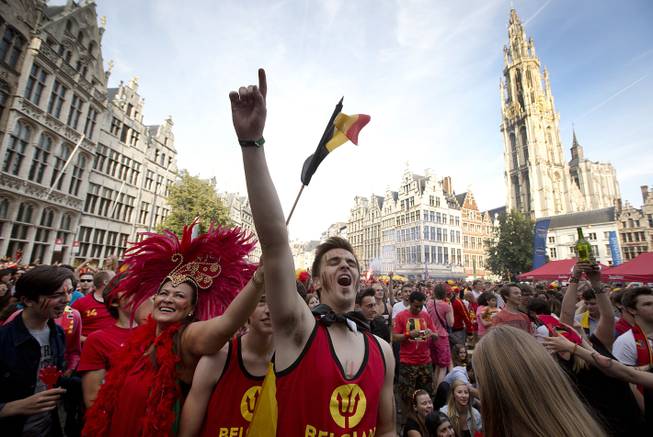 Belgian fans cheer after Belgium scored a goal as they watch the soccer match on a giant screen in the Grote Markt in Antwerp, Belgium on Sunday, June 22, 2014. Belgium scored a 1-0 victory over Russia during the group H World Cup soccer match between Belgium and Russia at the Maracana Stadium in Rio de Janeiro, Brazil.