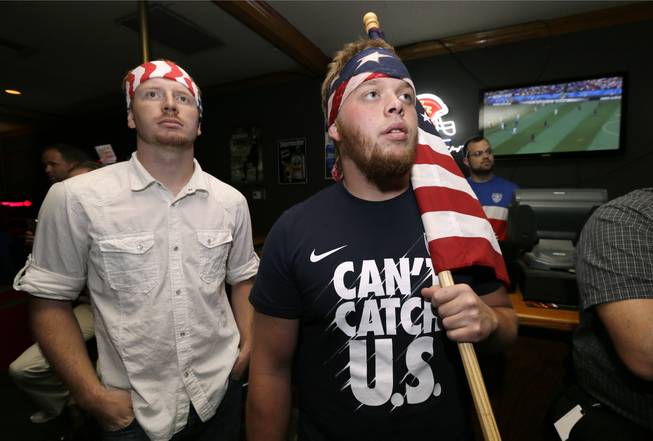 Aaron Todd, right, and Zach Crabtree, both of Knoxville, Iowa, watch the World Cup Soccer match between the United States and Germany at a local bar, Thursday, June 26, 2014, in West Des Moines, Iowa. Thousands of eager Americans set work aside on Thursday _ with or without their bosses’ OK _ to watch the key World Cup match. Todd and Crabtree said they took the day off to watch the match.