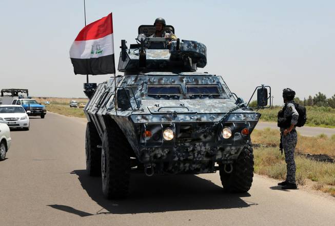 Iraqi federal policemen patrol in Baghdad's Abu Ghraib suburb Saturday, June 28, 2014. Iraqi troops backed by helicopter gunships launched an operation early Saturday aimed at dislodging Sunni militants from the northern city of Tikrit, one of two major urban centers they seized in recent weeks in a dramatic blitz across the country.
