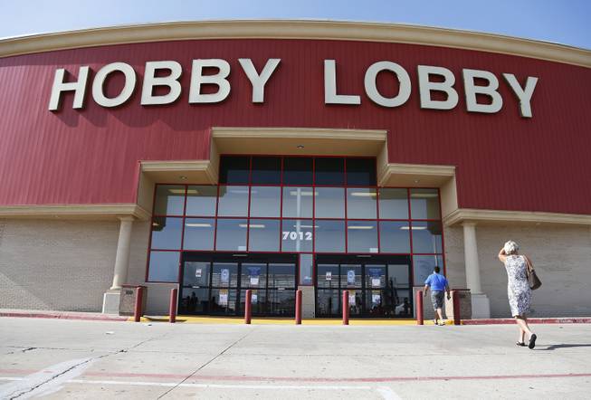 Customers walk to a Hobby Lobby store in Oklahoma City, Monday, June 30, 2014. The Supreme Court ruled Monday that employers can hold religious objections that allow them to opt out of the new health law requirement that they cover contraceptives for women. The Hobby Lobby chain of arts-and-crafts stores is by far the largest employer of any company that has gone to court to fight the birth control provision.