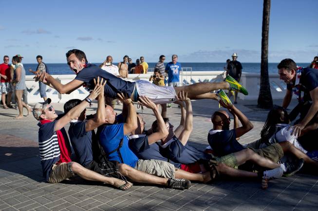 Fans of the French national soccer team celebrate their team's victory over Nigeria after watching the World Cup round of 16 match during the 2014 soccer World Cup in Salvador, Brazil, Monday, June 30, 2014. France's Paul Pogba scored with a late header to finally break Nigeria’s stubborn resistance and Joseph Yobo scored an own-goal as France won 2-0 to reach the World Cup quarterfinals on Monday.